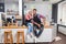 Barista coffee shop owner couple happy smile sitting on bar counter