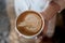 Barista creating latte art coffee.