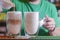 Barista creating latte art on long coffee with milk. Latte art in coffee mug. Barman pouring fresh coffee.