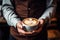 barista delicately holds a steaming cup of coffee adorned with captivating latte art. The aromatic brew and elegant