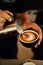 Barista expertly creates unique latte art on a  coffee