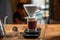 Barista expertly using a drip coffee maker to create a flavorful cup of coffee