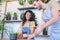 Barista giving glass of coffee to woman at table