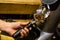 Barista grinds coffee beans in a coffee grinder.