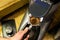 Barista grinds coffee beans in a coffee grinder.