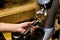 Barista grinds coffee beans in a coffee grinder.