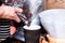 Barista hands pouring coffee grains to brown paper cup in caffe