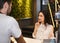 Barista Helping Client Girl Choose Coffee Drink Standing In Cafe