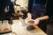 Barista holding plate with fresh coffee beans