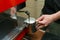 Barista makes coffees in bar. Latte preparation in coffee machine. Hands bartender cooking coffee, preparation milk for latte coff