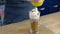 Barista makes irish coffee, pours liquid chocolate on whipping cream. Hands close-up.