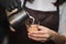 Barista making latte art focus in milk and coffee in crystal glass, worker order concept.