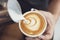 Barista making latte or Cappuccino art with frothy foam, coffee cup in cafe