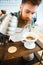 Barista pouring water on coffee ground with filter