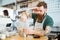 Barista pouring water in glass