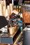 The barista prepares coffee and pours it into a paper cup against the backdrop of a coffee maker and a slide of empty paper cups