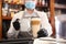 Barista preparing coffee at counter in restaurant, closeup. Catering during coronavirus quarantine