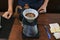 Barista preparing coffee pour over coffee maker and drip kettle.