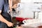 Barista preparing coffee at steaming machine