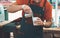 Barista preparing cup of coffee for customer outdoor