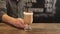 Barista putting cup of coffee down on counter in a cafe