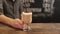 Barista putting cup of coffee down on counter in a cafe