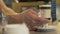 Barista putting prepared coffee latte in glass cup on table in cafe close up