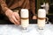 Barista serving tasty coffee drink on table