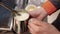 Barista steaming milk on coffee machine Spbi. Worker man hold mug with hot pouring foam drink.