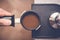 Barista tampering coffee in portafilter using tamper. Close-up fresh coffee preparation process