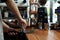 Barista tamping coffee in portafilter at bar counter, closeup