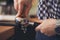 Barista tamping freshly ground coffee