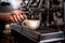 barista using Automatic coffee machines are working by distilling concentrated coffee water