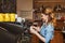 Barista woman making coffee by machine at cafe