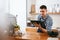 Barista Working On Tablet In Cafe