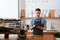 Barista Working On Tablet In Cafe