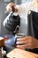 Baristas prepare hot coffee beans in cup pot. to make coffee for steam. Coffee shop concept. in cafe shop for drink,small business