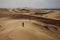 Barkhans of the Sahara desert. Tent in the sand. People in the desert