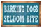 BARKING DOGS SELDOM BITE words on blue wooden frame school blackboard