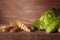 Barley ear and hops green cones on wooden dark table background with copy space