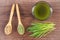 Barley grass with beverage and grain with young powder barley on spoon