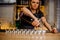 Barmaid pours alcohol into crystal stacks that are lined up