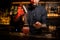 Barman adding spices powder into a cocktail glass