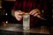 Barman decorating a glass of alcoholic lemonade drink