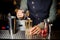 Barman decorating a sweet alcoholic cocktail with a flower