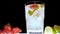 The barman makes an alcoholic drink, a pineapple, a black background