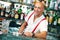 Barman portrait standing near bartender desk in restaurant bar