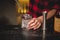 Barman pouring ice in glass.Bartender preparing cocktail drink.