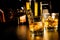 Barman pouring whiskey in front of bottles, focus on top of bottle