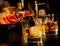 Barman pouring whiskey in front of whiskey glass and bottles